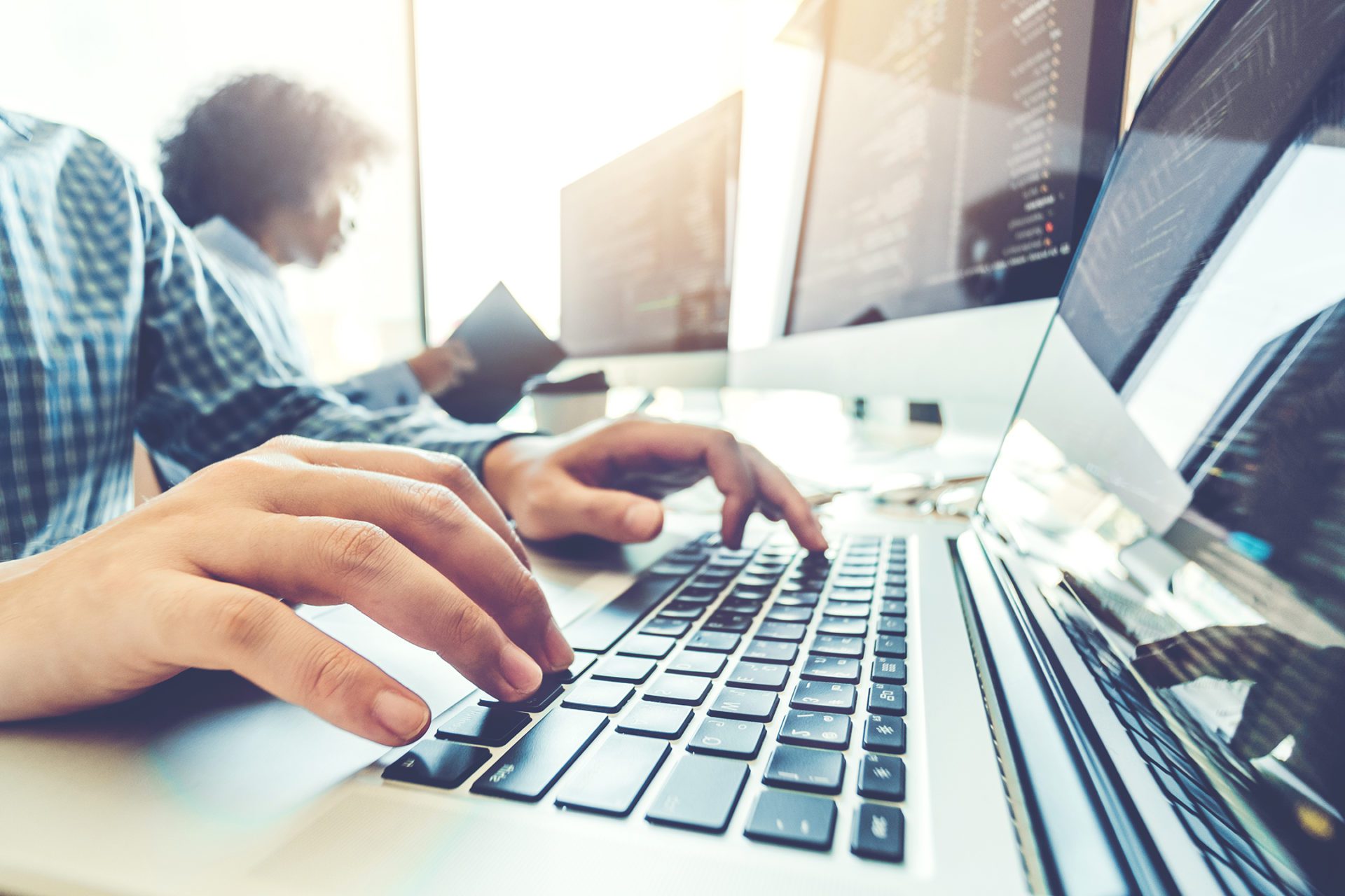 Image of a man typing on a computer